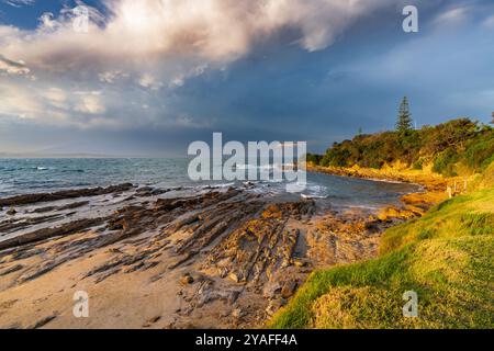 A dramatic storm cloud approaching over a rocky coastline at at Bermagui in New South Wales, Australia. Stock Photo