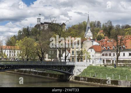 Ljubljana, Slovenia, 04 13 2018: Bridge and the banks of the river with the city monuments in the background, Europe Stock Photo