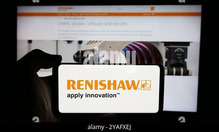 Germany. 08th Aug, 2024. In this photo illustration, a person is holding a cellphone with the logo of British engineering company Renishaw plc in front of business webpage. (Photo by Timon Schneider/SOPA Images/Sipa USA) *** Strictly for editorial news purposes only *** Credit: Sipa USA/Alamy Live News Stock Photo