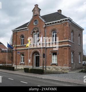 Merchtem, Flemish Brabant Region, Belgium, Feb. 25 2023, Facade with flags of the village and municipality hall, Europe Stock Photo