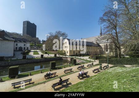 Ixelles, Brussels, Belgium, 03 30 2019: Panoramic ultra wide view over the park and site of the La Cambre Abbey with people sitting around the water p Stock Photo