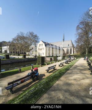 Ixelles, Brussels, Belgium, 03 30 2019: Panoramic ultra wide view over the park and site of the La Cambre Abbey with people sitting around the water p Stock Photo