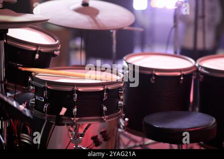 Close up of electronic five-piece drum kit with cymbals on stage. Selective focus. Stock Photo