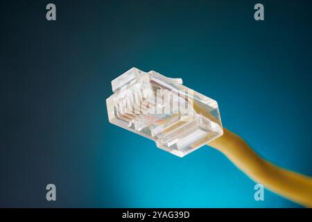 close-up of rj-45 ethernet networking jack connector isolated blue background, used to connect computers, routers and other devices over wan Stock Photo