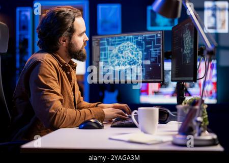 Programmer writing code on computer and doing maintenance on artificial intelligence neural networks computerized model. Tech support expert typing on keyboard, doing checkup on AI systems Stock Photo