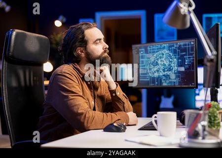 Computer scientist using PC to maintenance artificial intelligence neural networks simulating human thought processes in computerized model. Tech support worker doing checkup on AI systems Stock Photo