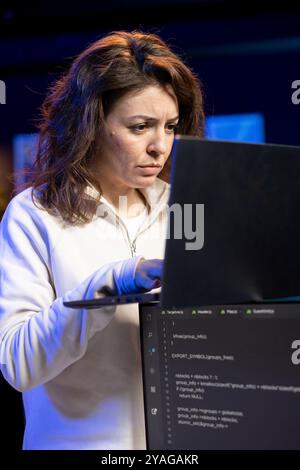 Programmer typing on laptop keyboard, implementing and maintaining security measures. Expert writing, testing and debugging Java code for software applications on notebook device Stock Photo