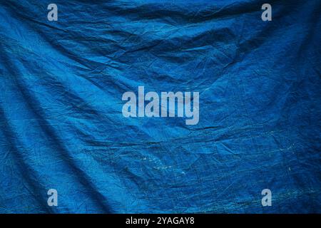 Worn blue tarpaulin material texture as background Stock Photo