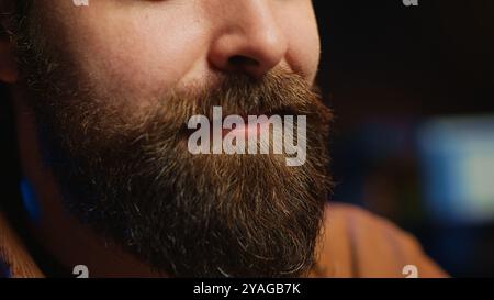 Happy computer scientist feeling satisfied after removing all bugs while coding on workstation desktop. Teleworking upbeat IT specialist pleased after solving script errors, camera A extreme close up Stock Photo