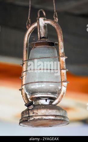 Old hanging metal oil lamp close-up. Stock Photo