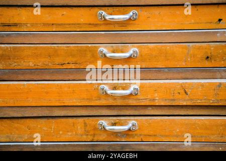 Old magazine close-up. Wooden chest with many drawers. Stock Photo