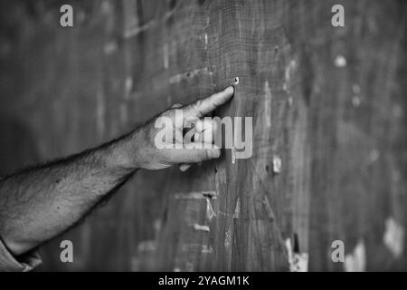 Senior engineer is pointing at a detail on a wall, potentially explaining a technical aspect or identifying an area of concern Stock Photo