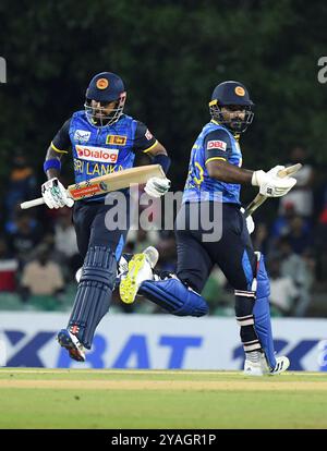 Dambulla, Sri Lanka. 13th Oct, 2024. Sri Lanka's Kusal Perera (R) and captain Charith Asalanka run between the wickets during the T20 International Cricket Match between Sri Lanka and West Indies at the Rangiri Dambulla International Cricket Stadium in Dambulla, Sri Lanka, on Oct. 13, 2024. Credit: Ajith Perera/Xinhua/Alamy Live News Stock Photo