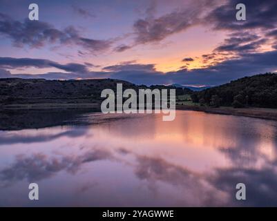 Aerial view of the Estany de Montcortès lake, on a cloudy sunrise in Baix Pallars (Pallars Sobirà, Lleida, Catalonia, Spain, Pyrenees) Stock Photo