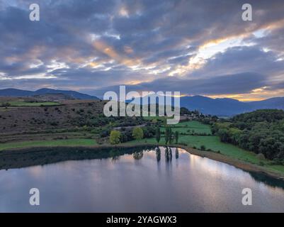 Aerial view of the Estany de Montcortès lake, on a cloudy sunrise in Baix Pallars (Pallars Sobirà, Lleida, Catalonia, Spain, Pyrenees) Stock Photo