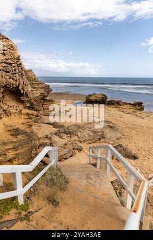 White stairs leading down to rocky sandy beach, Point Lonsdale Stock Photo