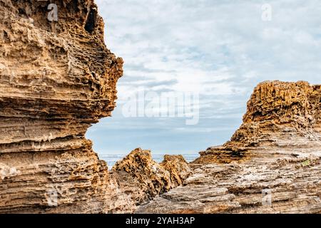 Close-up of rugged coastal rock formations with ocean in background Stock Photo