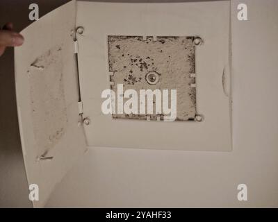 Dirty and dusty air ventilation system filter in the bathroom. Stock Photo