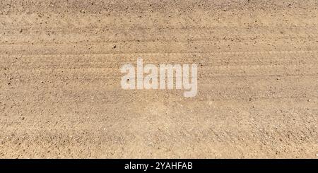 view from above on texture of dry muddy road with tractor tire tracks in countryside Stock Photo