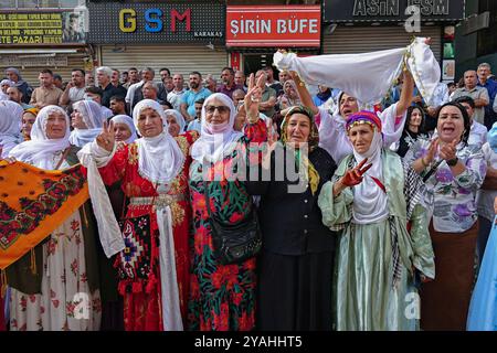 Kurdish women are seen making victory signs at a celebratory rally ...