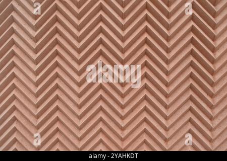 Pattern of textured zigzag lines on a terracotta wall. Backgrounds and textures. Stock Photo