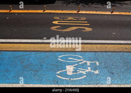 Messina city in Italy. Bicycle lane road marking next to separate bus lane. Stock Photo