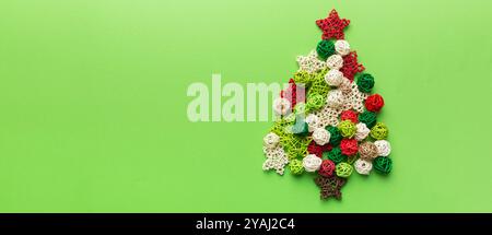 Christmas tree made from colored handmade ball decoration on colored background, view from above. New Year minimal concept with copy space. Stock Photo