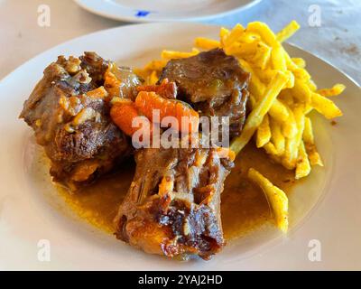 Oxtail stew with fried potatoes. Spain. Stock Photo