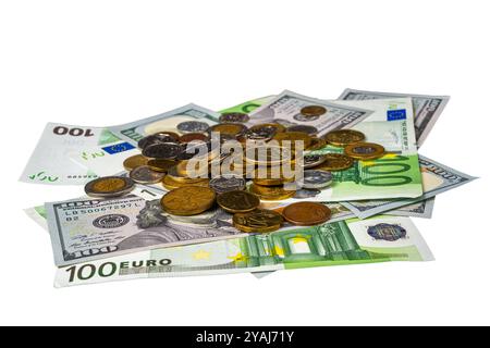 A close-up image showing a mix of euro and dollar bills with various coins on top, representing currency exchange and financial concepts. Stock Photo