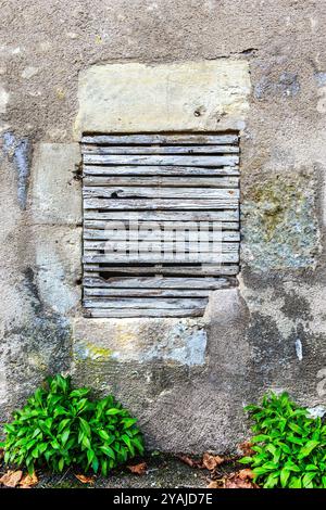 Blocked broken window in stone wall of old building - Le Petit-Pressigny, Indre-et-Loire (37), France. Stock Photo
