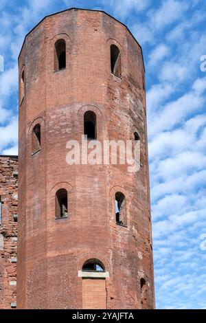 cityscape with sixteen sided tower at Porta Palatina, Augusta Taurinorum Roman city gate, shot  in bright fall light at Torino, Italy Stock Photo