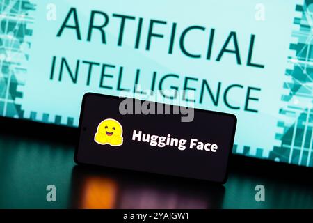 August 31, 2024, Paraguay. In this photo illustration, the Hugging Face logo is displayed on a smartphone screen and in the background the text artifi Stock Photo