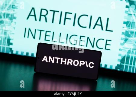 August 31, 2024, Paraguay. In this photo illustration, the Anthropic logo is displayed on a smartphone screen and in the background the text artificia Stock Photo
