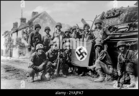 Post D-Day group of Americans from the 359th Inf. Rgt. of the 90th US Inf. Div. pose with captured tank  II/Pz.Rgt.16 of the 116. Nazi Panzer-Division whilst holding their trophy: a German signal flag with swastika. Normandy 1944 WW2 Northern France American troops celebrate holding swastika flag with capture of German Nazi tank & occupied French village Normandy France US soldiers celebrate with a captured German flag in front of destroyed Panther tank. The group of infantrymen were left behind to 'mop-up' in Chambois, France, last stronghold of the Germans in the Falaise Gap Normandy France Stock Photo