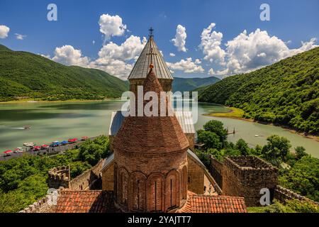 view of the two church domes and the green waters and hills of the ananuri fortress georgia Stock Photo