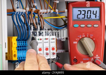 Measuring Voltage in Electrical Panel with Multimeter Stock Photo