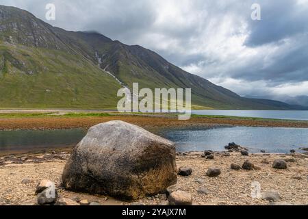 The waters of Loch Etive reflecting the surrounding mountains, with the snow capped peak of Ben Cruachan in the distance, Argyll and Bute, Scotland. Stock Photo