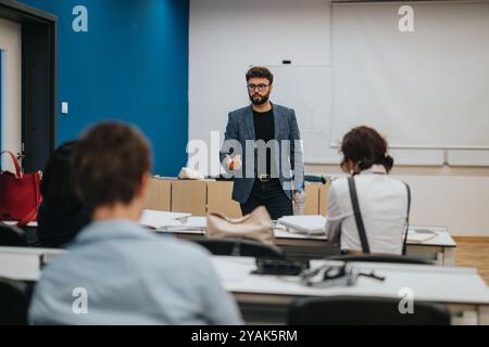 Professor assisting students during interactive classroom session Stock Photo