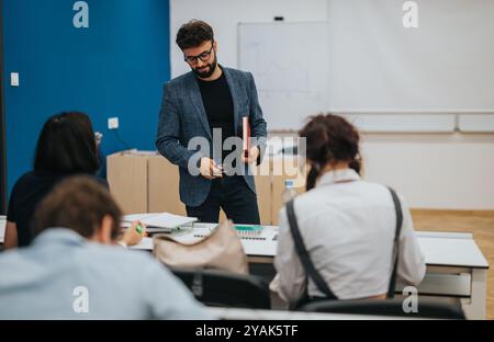 Professor assisting students during an engaging classroom session Stock Photo