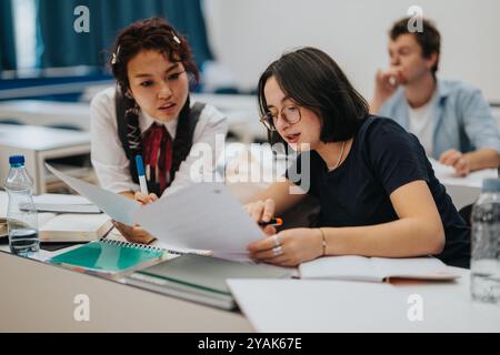 Students engaging in collaborative learning during classroom session Stock Photo