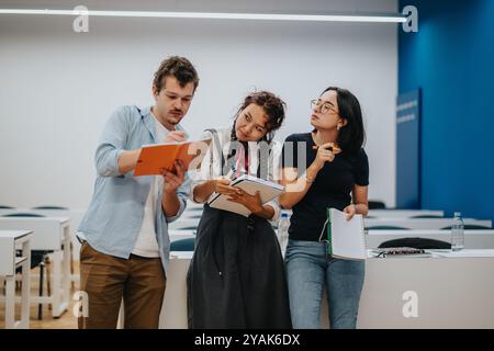 Group of students collaborating on a project in classroom Stock Photo