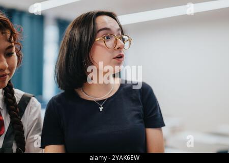 Engaged students having a discussion in the classroom setting Stock Photo