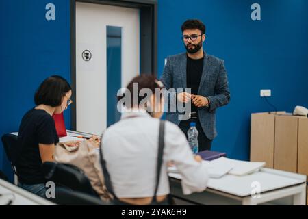 Professor assisting students during a class in modern classroom Stock Photo