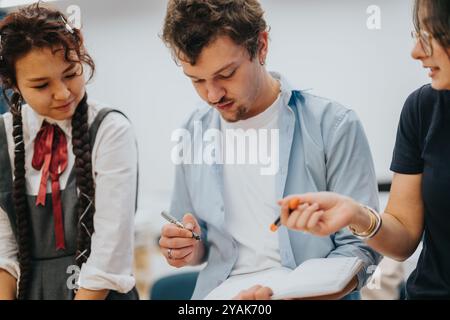 Students collaborating on a school project in classroom setting Stock Photo