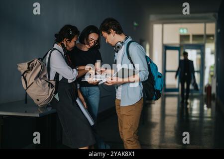Group of students collaborating in a school hallway between classes Stock Photo