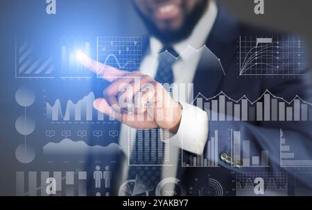 Businessman choosing with finger analytic diagram with data Stock Photo