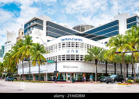 South Beach, USA - January 17, 2021: The Ritz-Carlton hotel luxury resort by Walgreens pharmacy in Miami Florida, people walking on street in summer Stock Photo