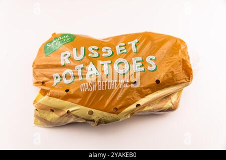 Avon, USA - August 4, 2022: Russet potatoes potato vegetable root food bag by Signature farms Safeway private label brand on white background Stock Photo