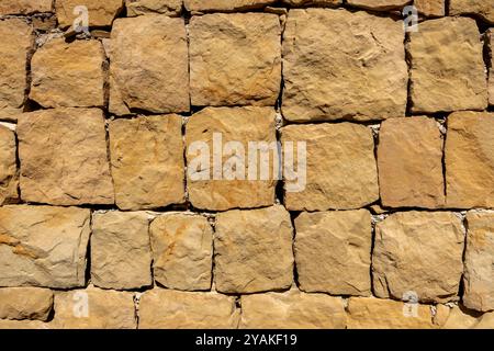 Large sandstone block patterned brick wall closeup background and texture Stock Photo