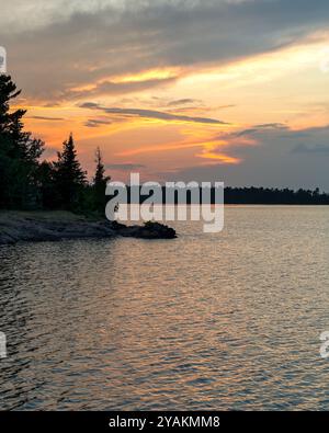 Sunset over water in the Northwoods.  Lake Superior in Michigan's Upper Peninsula.  Copy space if needed.  Concepts could include nature, travel, tour Stock Photo
